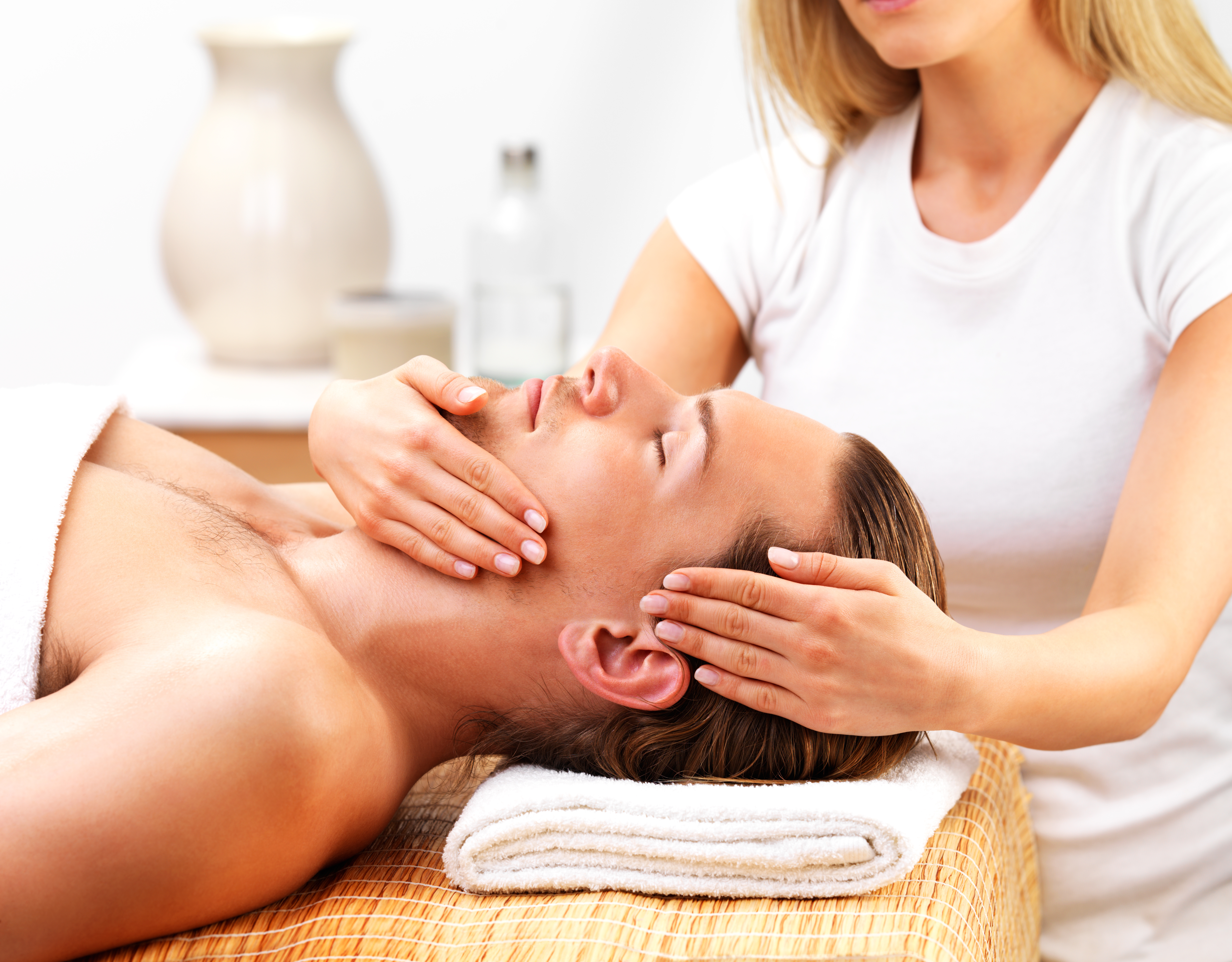 Portrait of handsome man getting massage